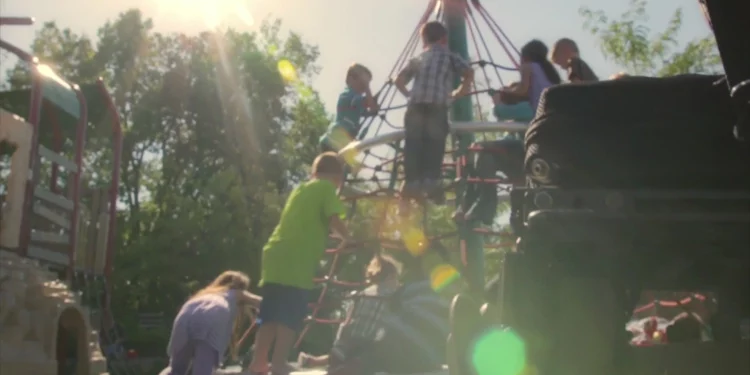 Disabled children playing on an inclusive playground